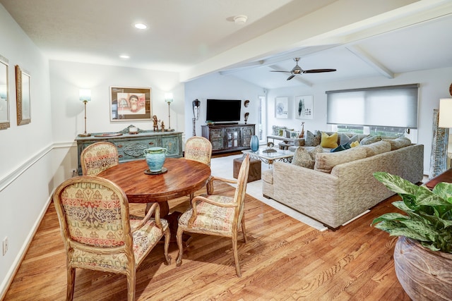 living room featuring vaulted ceiling with beams, ceiling fan, and light hardwood / wood-style flooring