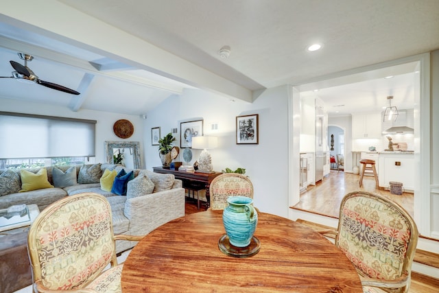 dining space with lofted ceiling with beams, light hardwood / wood-style flooring, and ceiling fan