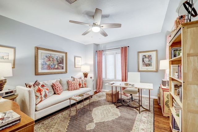 living room featuring hardwood / wood-style flooring and ceiling fan