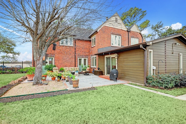 rear view of house with an outdoor living space, a patio area, and a lawn