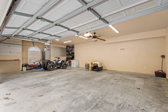 garage featuring ceiling fan and a garage door opener