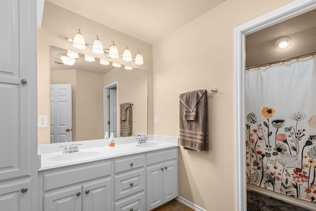 bathroom featuring double sink and vanity with extensive cabinet space