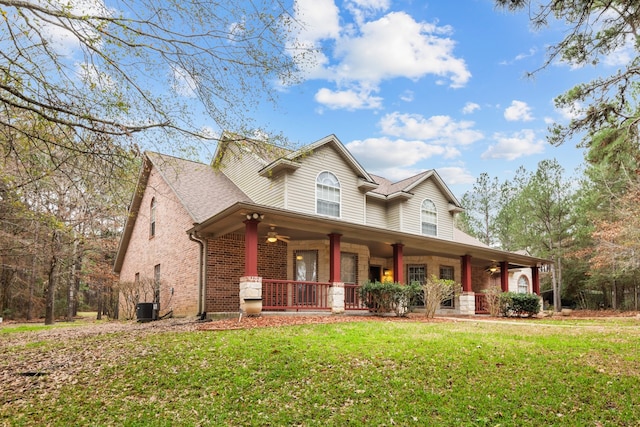 view of front of property featuring a porch, central AC, and a front lawn