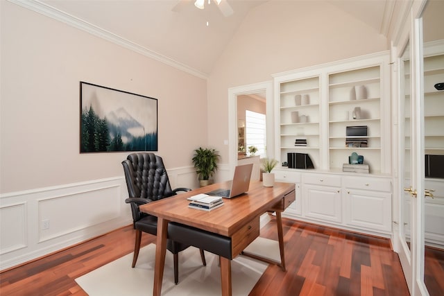 office area with vaulted ceiling, ceiling fan, crown molding, dark wood-type flooring, and built in shelves