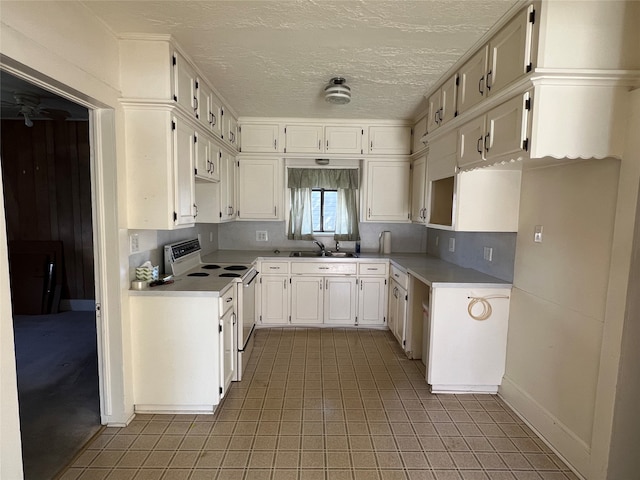 kitchen featuring tile flooring, white range with electric cooktop, sink, and white cabinets