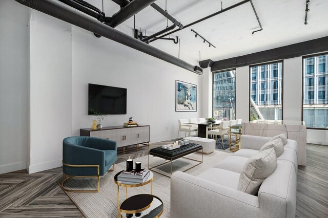 living room featuring track lighting and parquet flooring