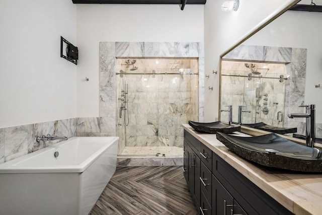 bathroom with parquet floors, shower with separate bathtub, and vanity