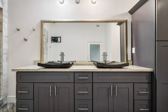 bathroom with double vanity and wood-type flooring