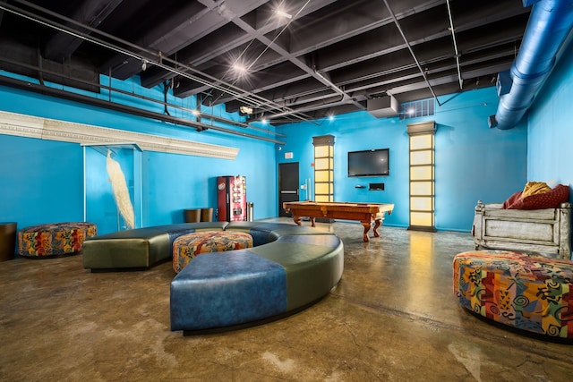 living room featuring concrete flooring and billiards