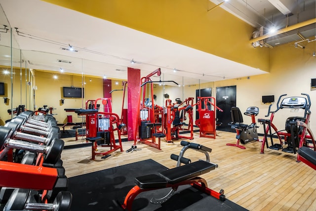 exercise room with hardwood / wood-style flooring