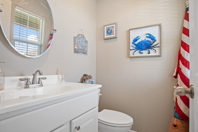 bathroom featuring toilet and large vanity