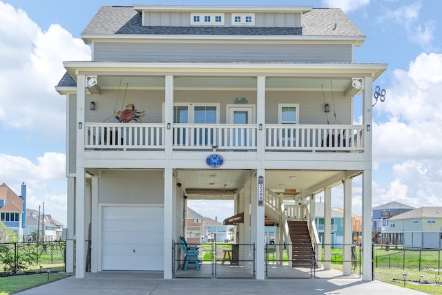 view of front of house featuring a balcony, a porch, and a garage