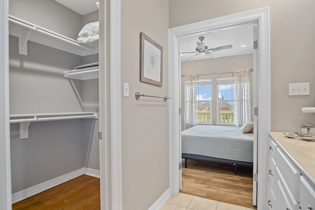 bathroom with vanity, ceiling fan, and wood-type flooring