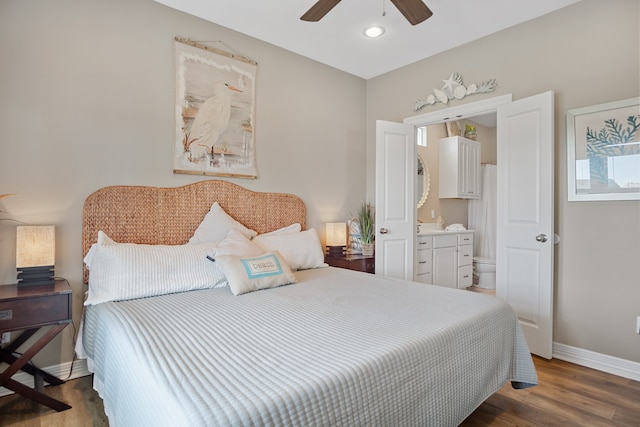 bedroom with ceiling fan, ensuite bath, and dark hardwood / wood-style floors