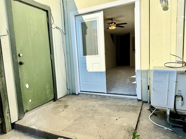 view of exterior entry featuring ceiling fan