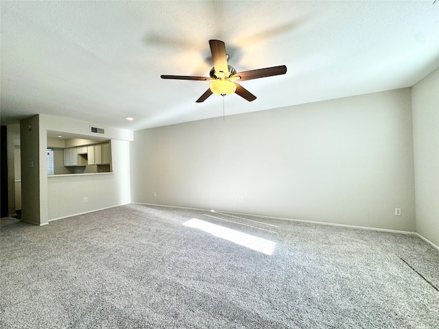 unfurnished living room with ceiling fan, carpet, and a textured ceiling