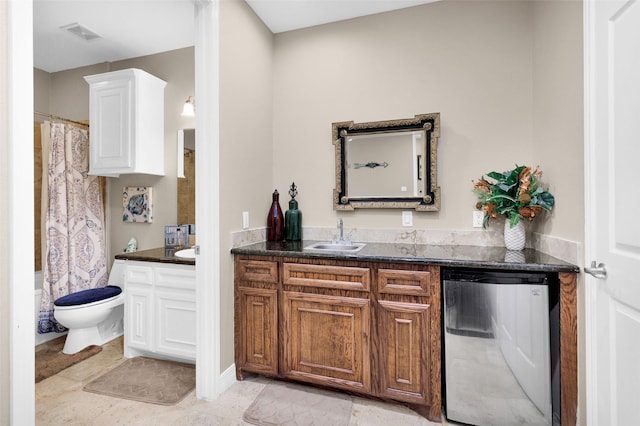 bar featuring refrigerator, dishwasher, white cabinetry, sink, and dark stone counters