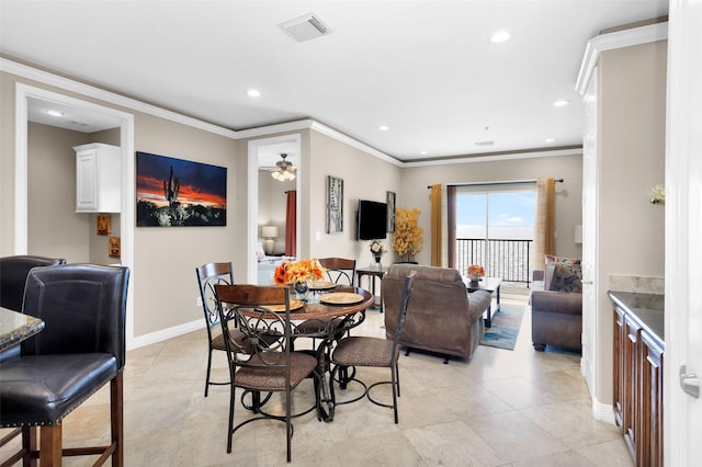 dining area with crown molding, ceiling fan, and light tile patterned floors