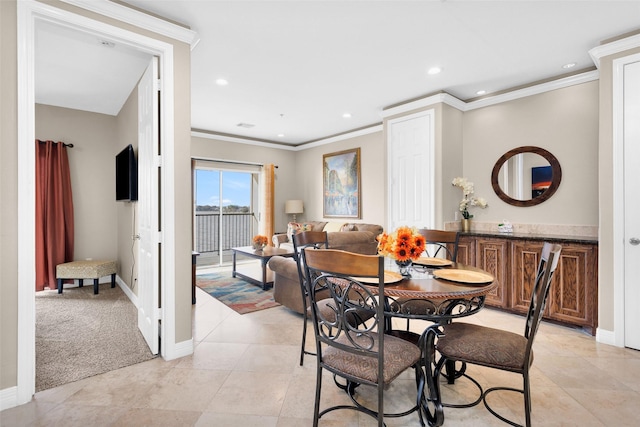 tiled dining room featuring crown molding