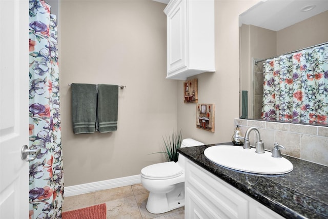 bathroom with tasteful backsplash, tile patterned floors, vanity, and toilet