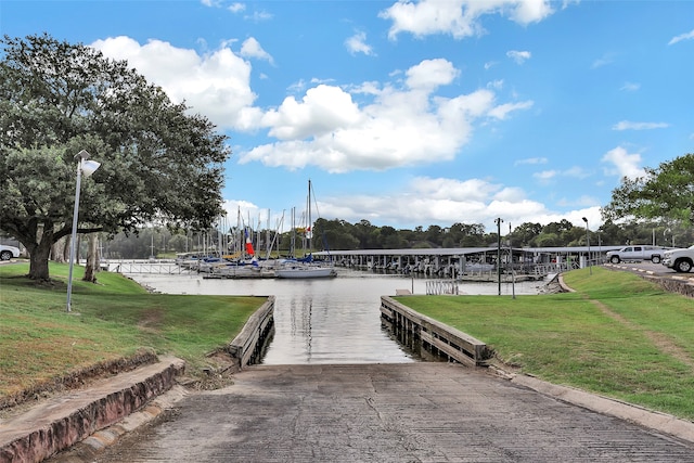 dock area with a yard and a water view