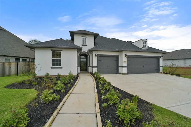 view of front of house featuring a front lawn and a garage