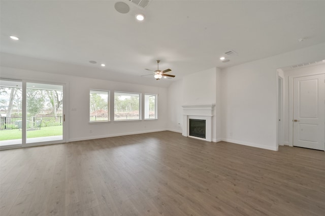 unfurnished living room featuring ceiling fan and hardwood / wood-style flooring