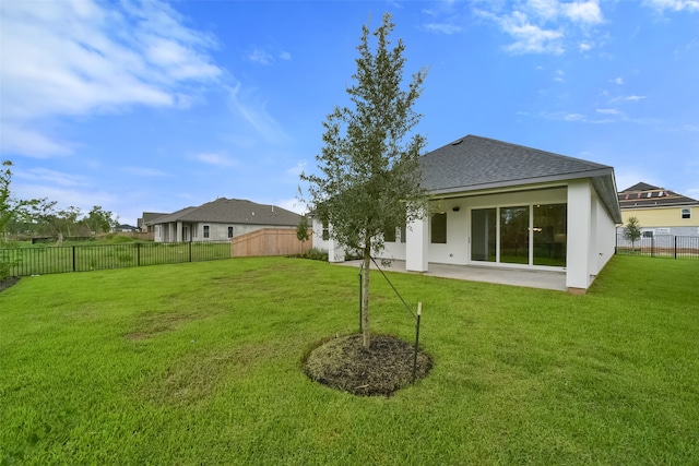 back of property featuring a yard and a patio