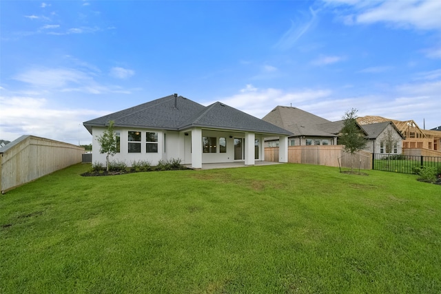 back of property featuring a lawn and a patio area