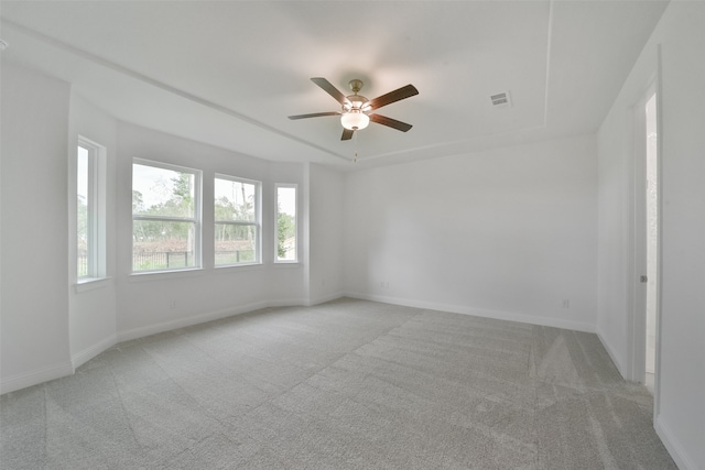 carpeted spare room with ceiling fan