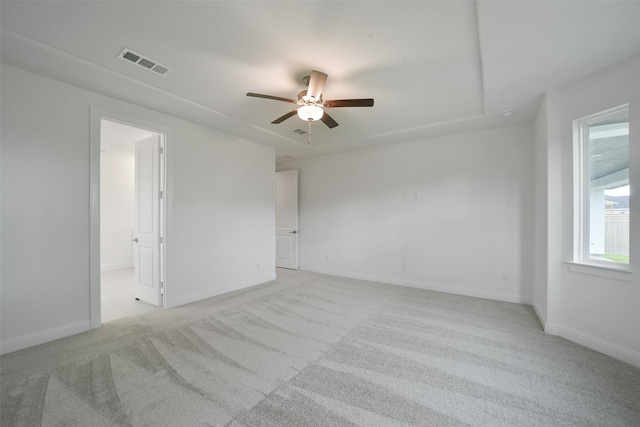 carpeted spare room with ceiling fan