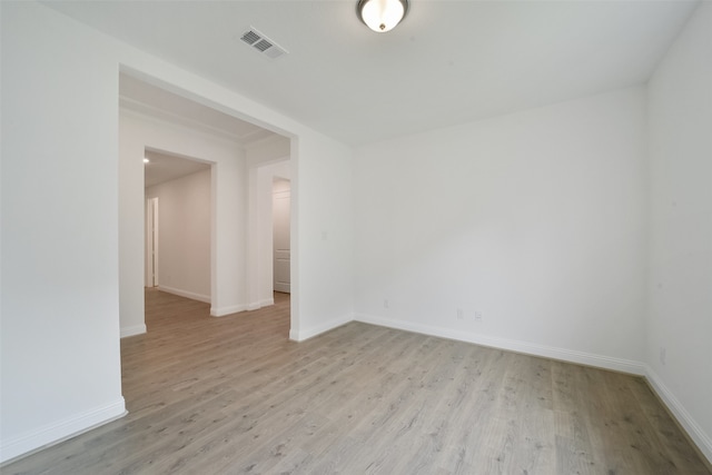 unfurnished room with light wood-type flooring