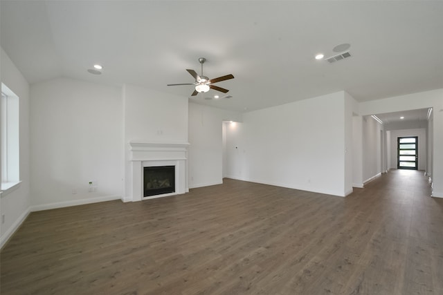 unfurnished living room featuring vaulted ceiling, dark hardwood / wood-style floors, and ceiling fan