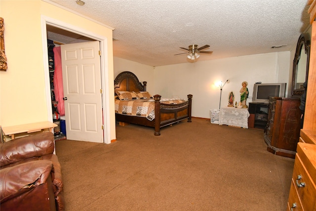 carpeted bedroom featuring a textured ceiling and ceiling fan