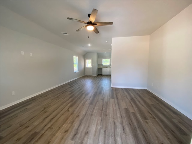 spare room with baseboards, ceiling fan, and wood finished floors