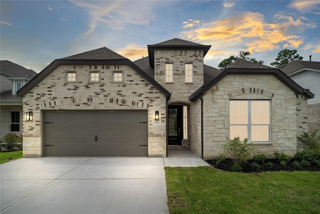 french country inspired facade with a garage and a yard