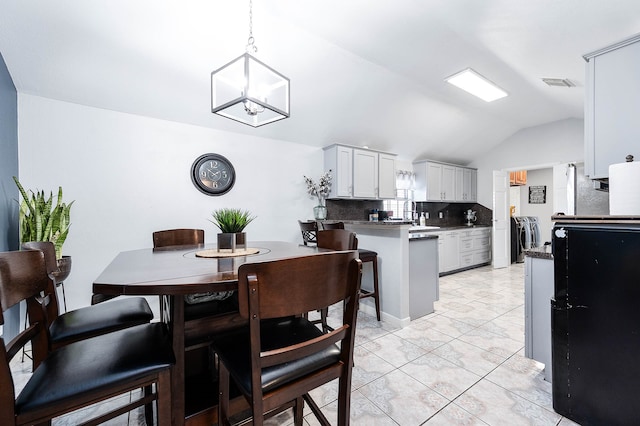 kitchen with pendant lighting, a notable chandelier, light tile floors, white cabinetry, and backsplash