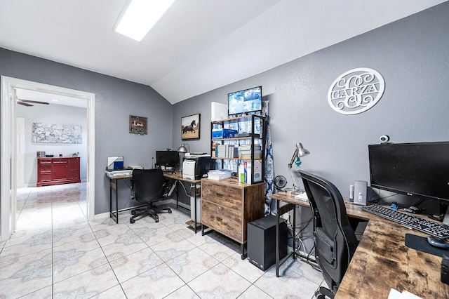 office featuring ceiling fan, light tile flooring, and vaulted ceiling