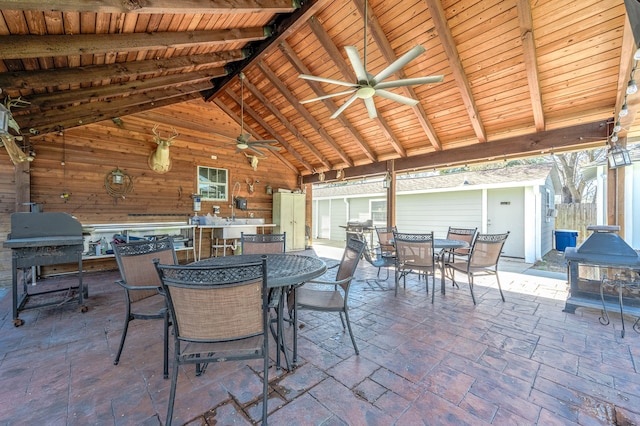 view of terrace featuring an outdoor structure and ceiling fan