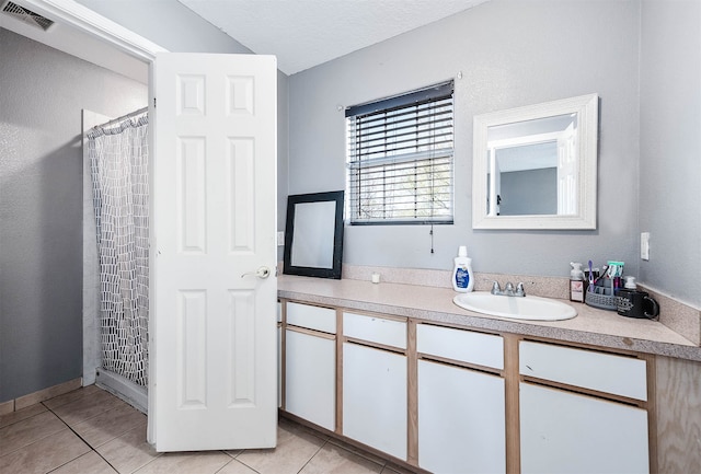 bathroom featuring tile flooring and vanity