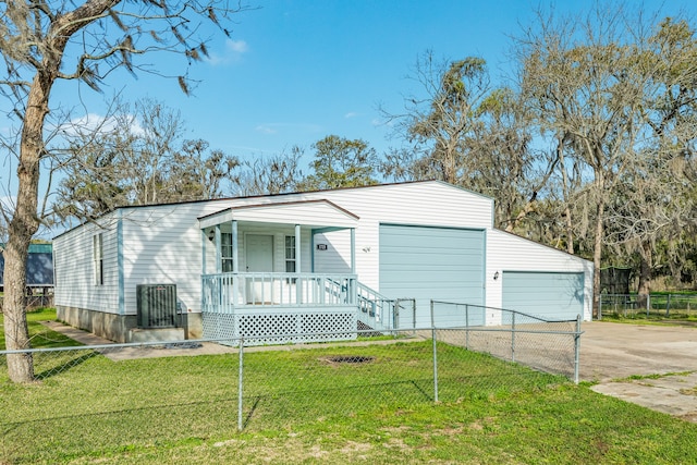 view of front of home featuring a porch, a front yard, and a garage