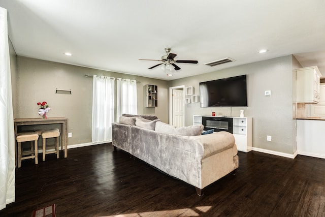 living room with dark hardwood / wood-style floors and ceiling fan