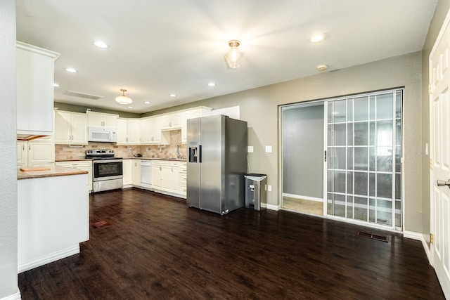 kitchen featuring white cabinets, tasteful backsplash, stainless steel appliances, and dark hardwood / wood-style flooring