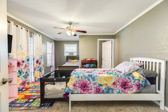 carpeted bedroom featuring crown molding, a textured ceiling, and ceiling fan