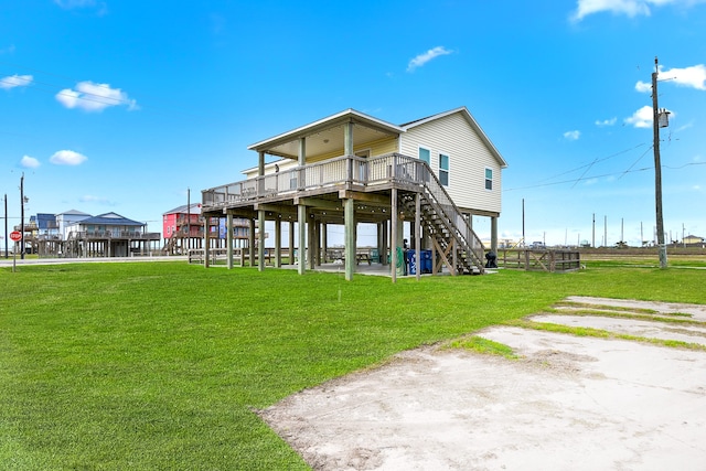 back of property with a deck and a lawn