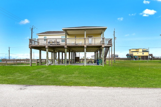 rear view of property with a deck and a yard