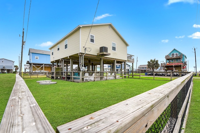 rear view of property featuring a lawn