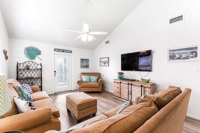 living room with ceiling fan, light hardwood / wood-style flooring, and high vaulted ceiling