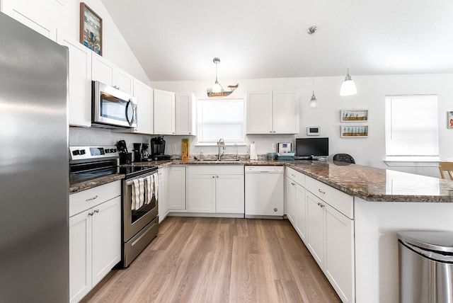 kitchen with stainless steel appliances, light wood-type flooring, and white cabinetry