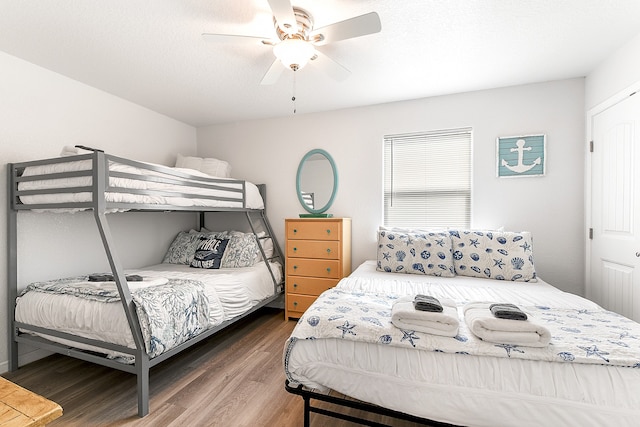 bedroom with dark hardwood / wood-style flooring and ceiling fan